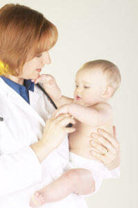 pediatrician holding baby in diaper