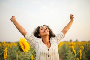 excited woman in sunflower field