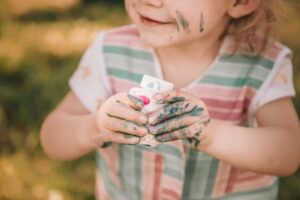 messy child with paint hands