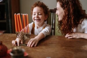 Jewish mother and son with menorah