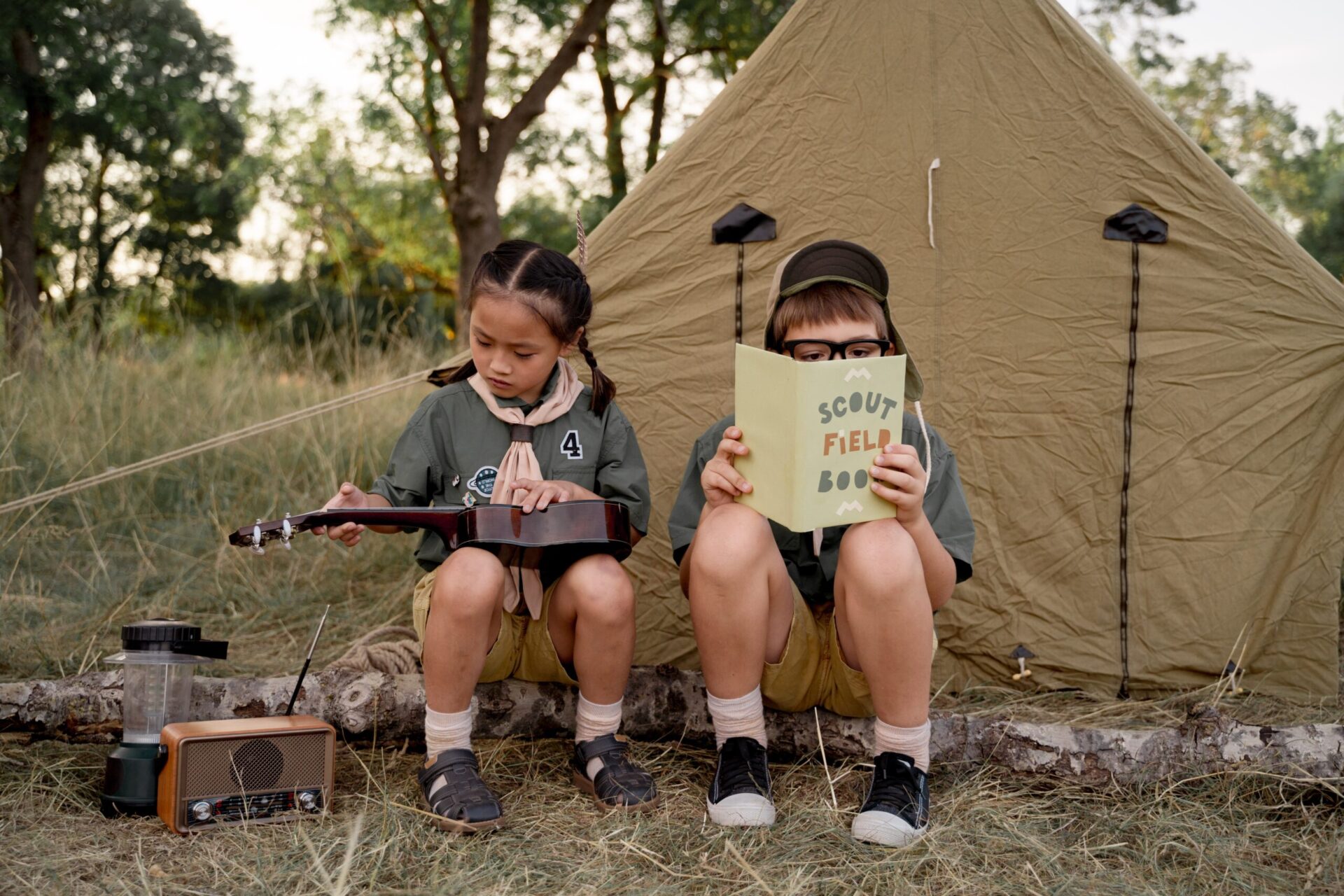 children sitting on a long camping