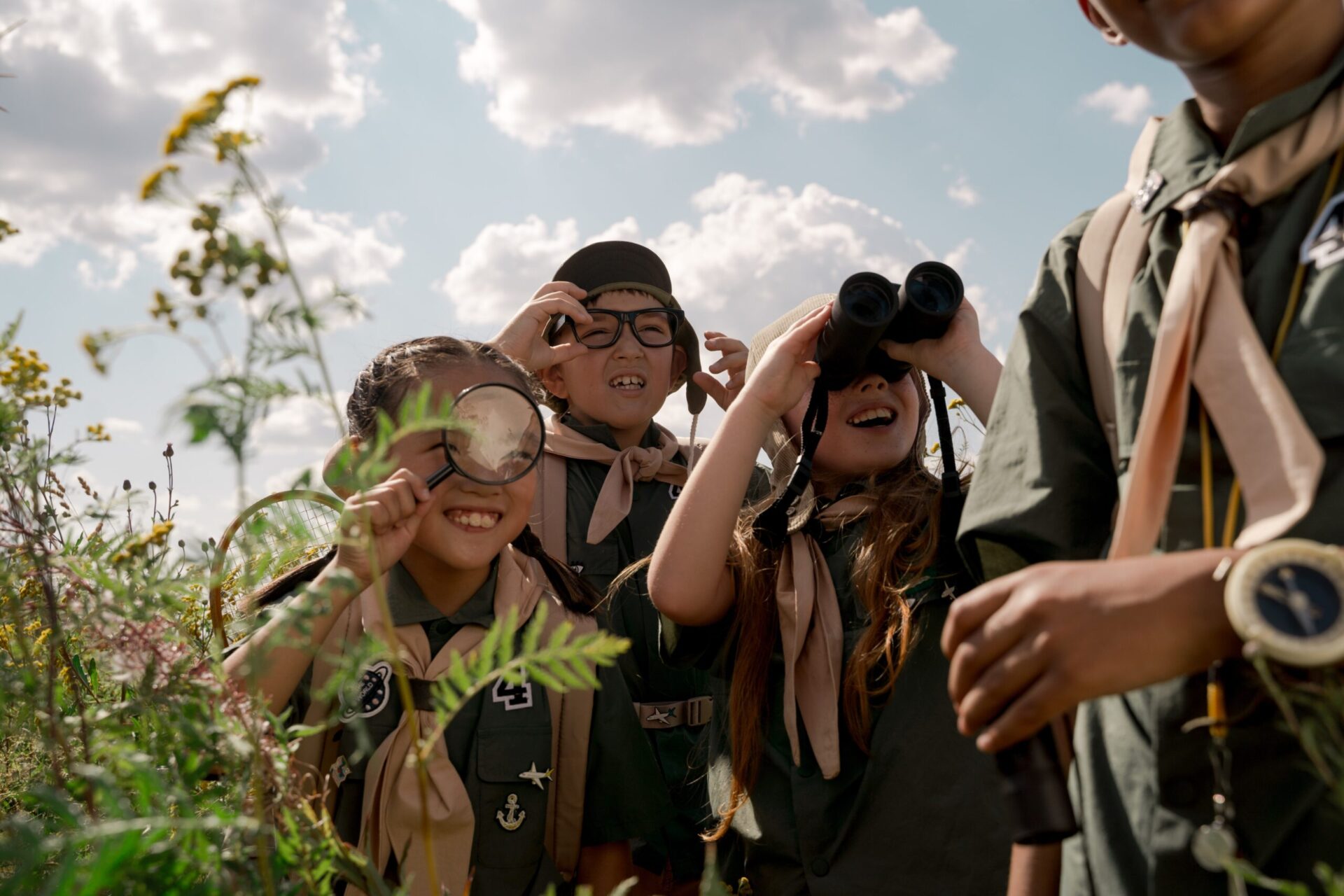 children looking through binoculars