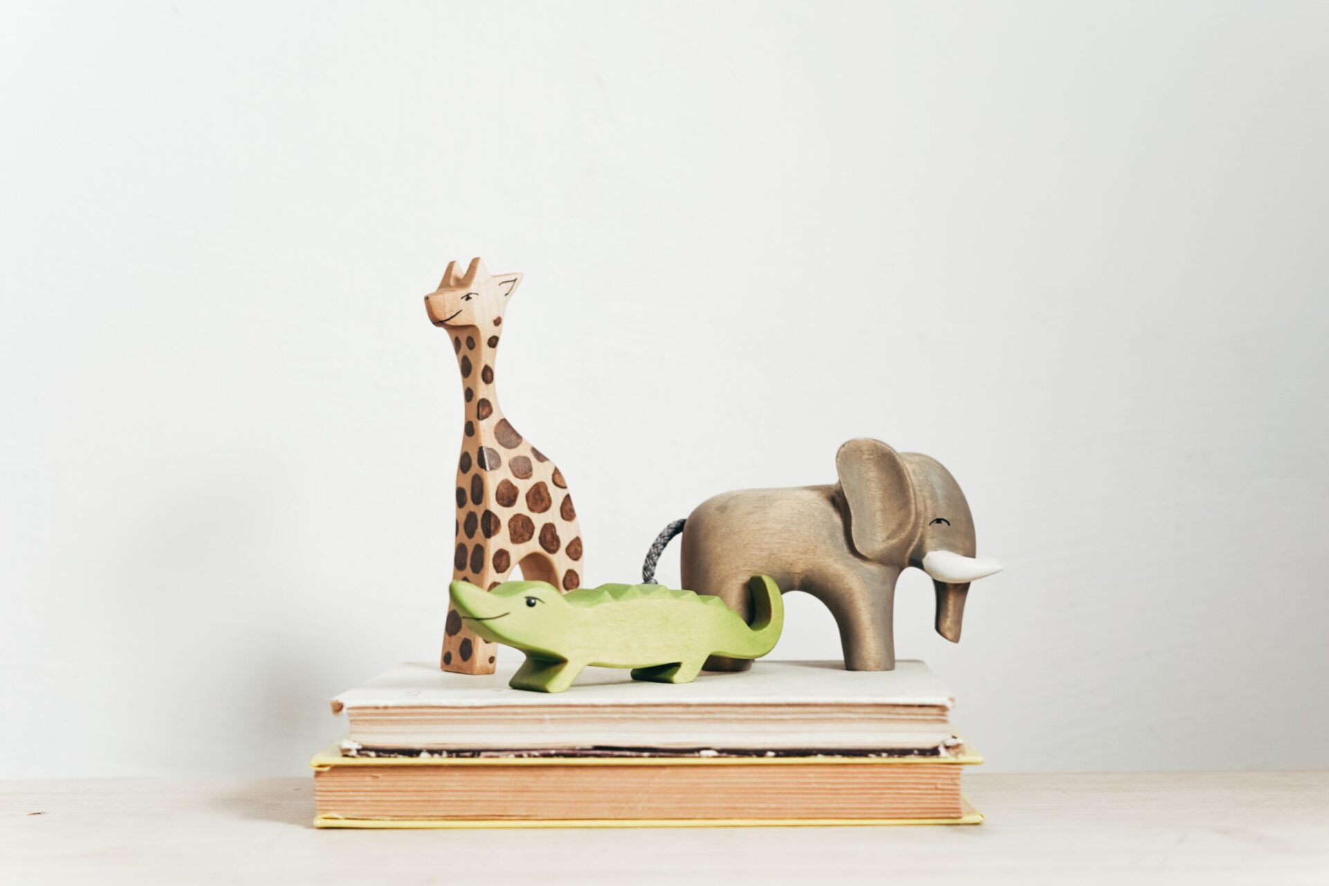 animal figurines on book stack
