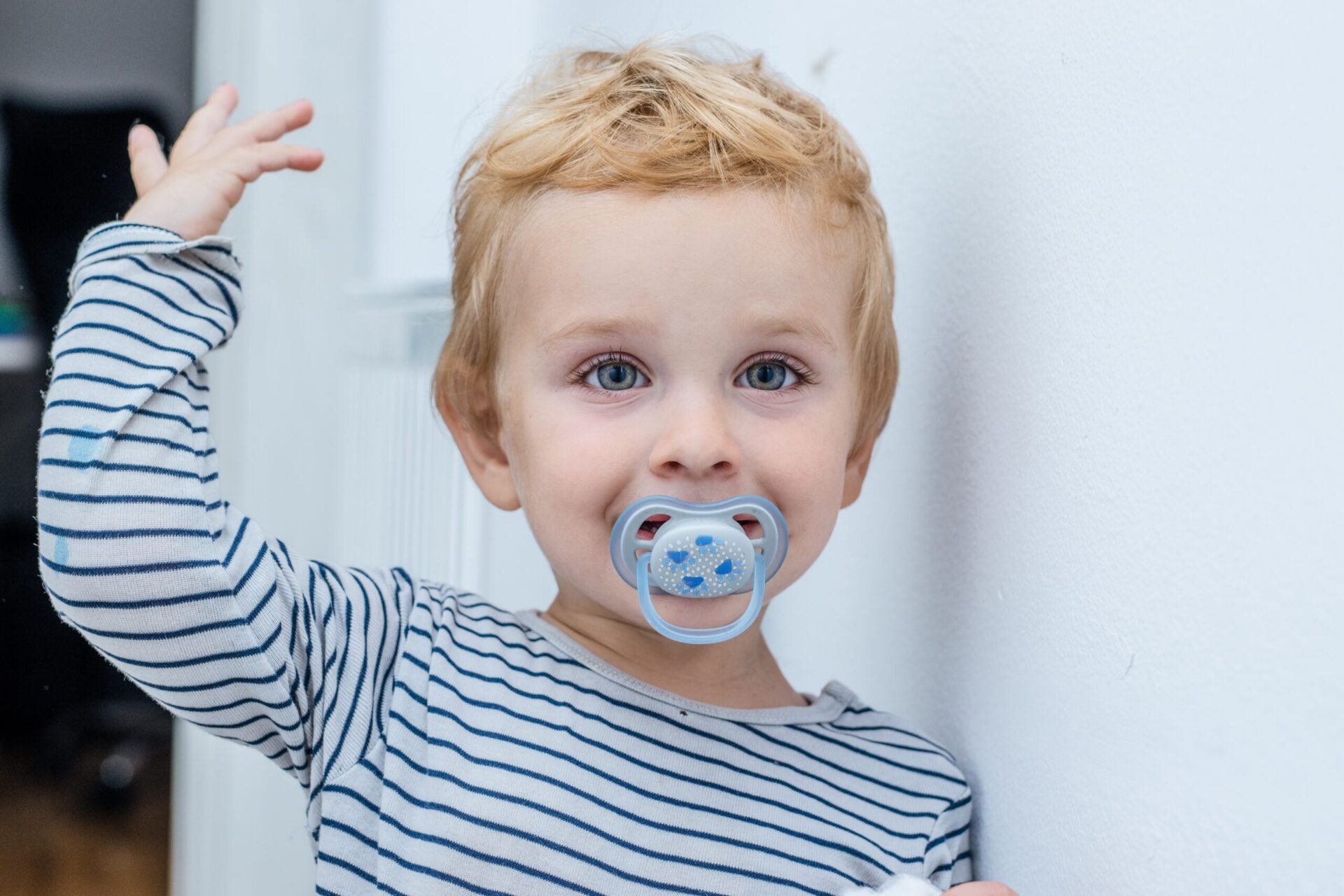 boy smiling with pacifier