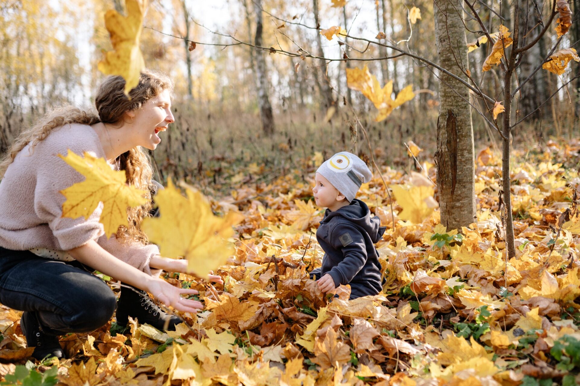 mother and child in fall leaves