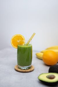 green smoothie with fruit wedge